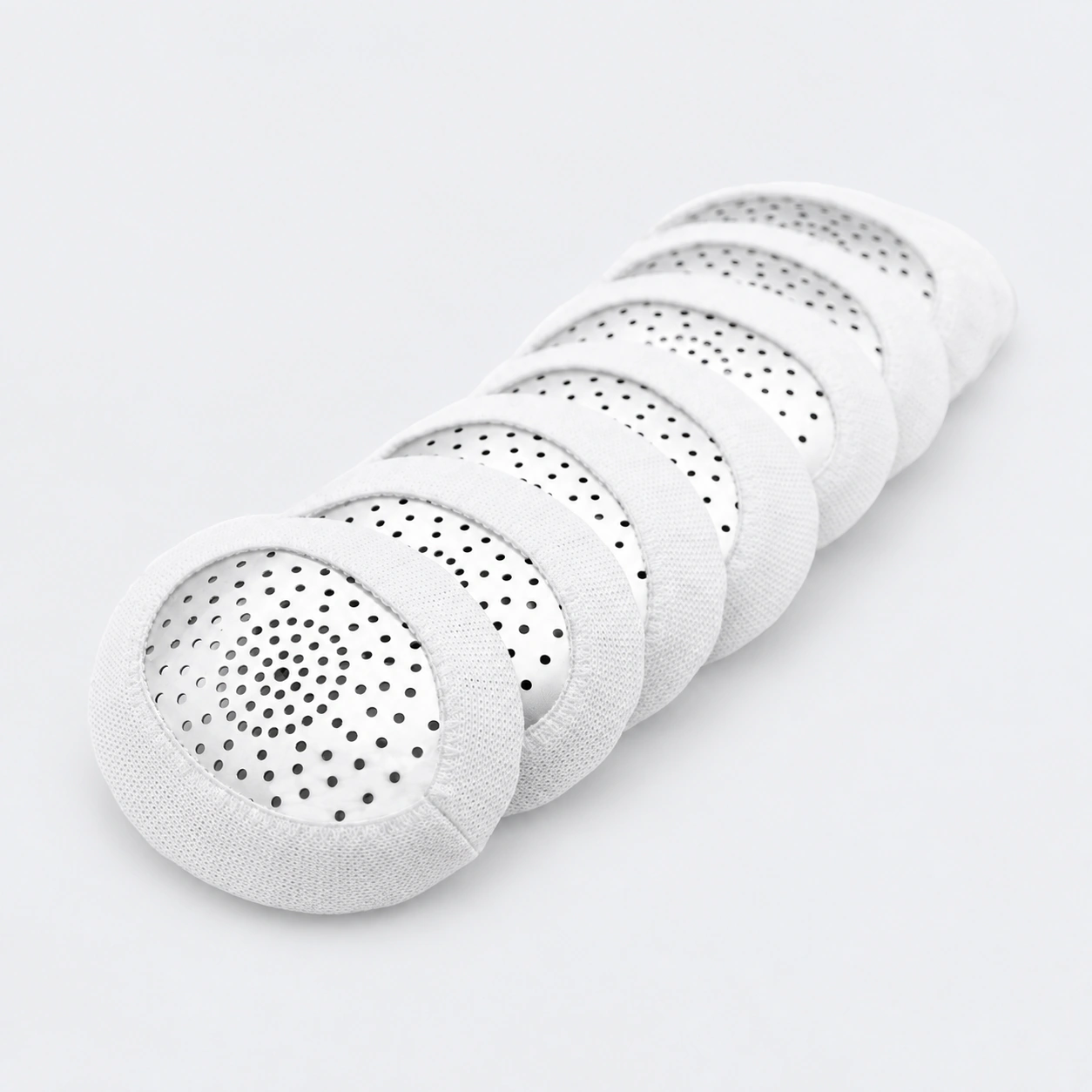 Stack of Fox aluminum pinhole eye shields with white loop covers